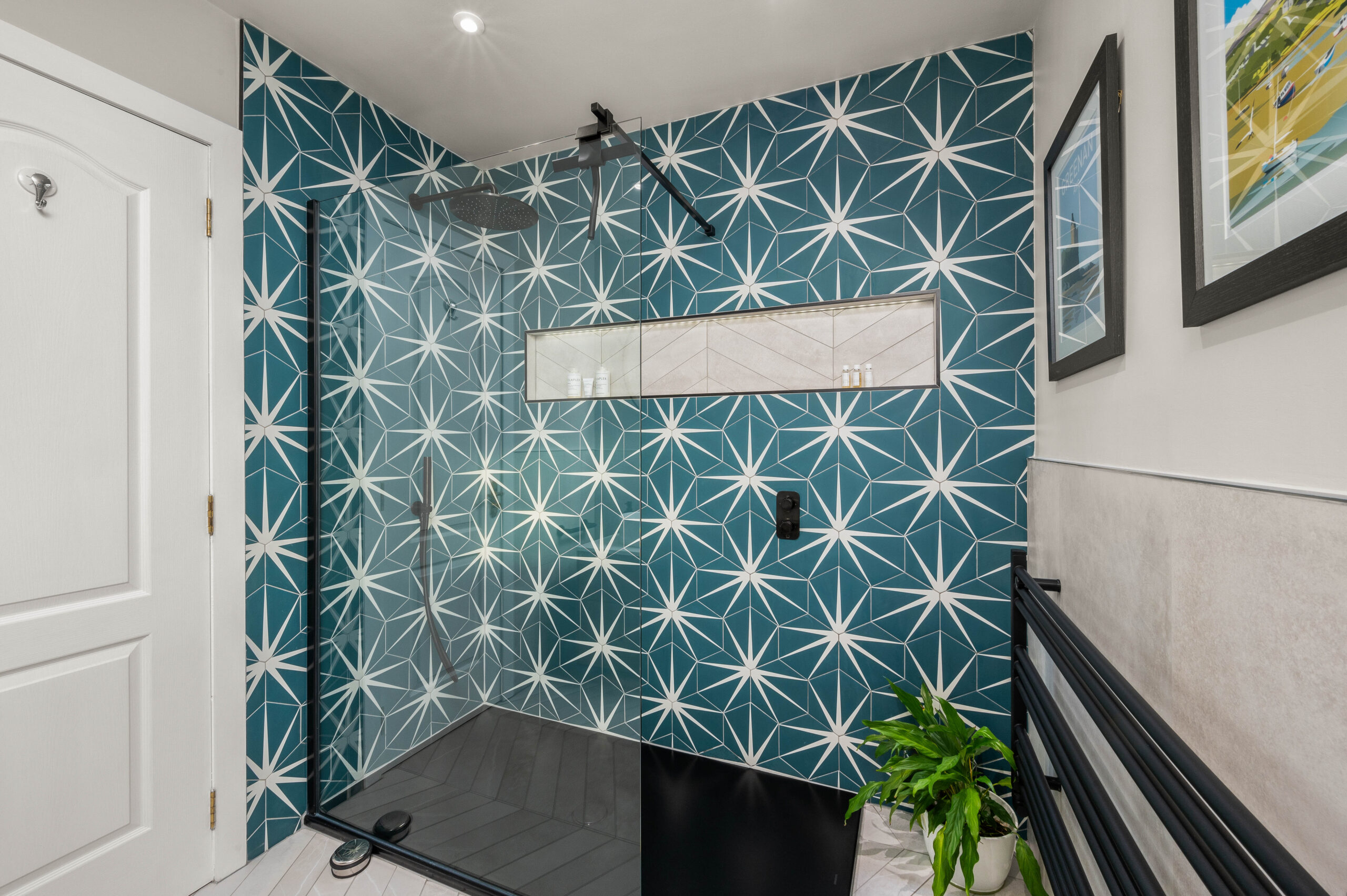 Bathroom Design from Whytes with a blue and white tiles wall behind the shower area